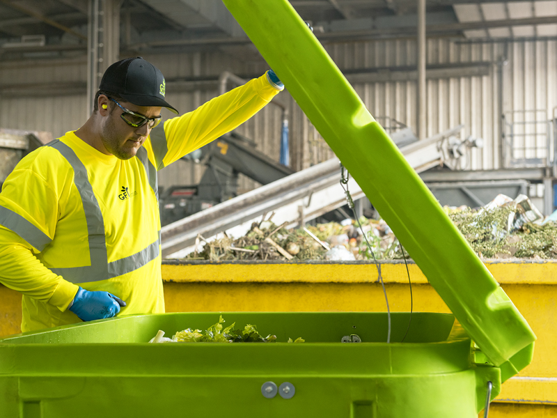 Organic Composting Services GFL employee performs organic composting services.
